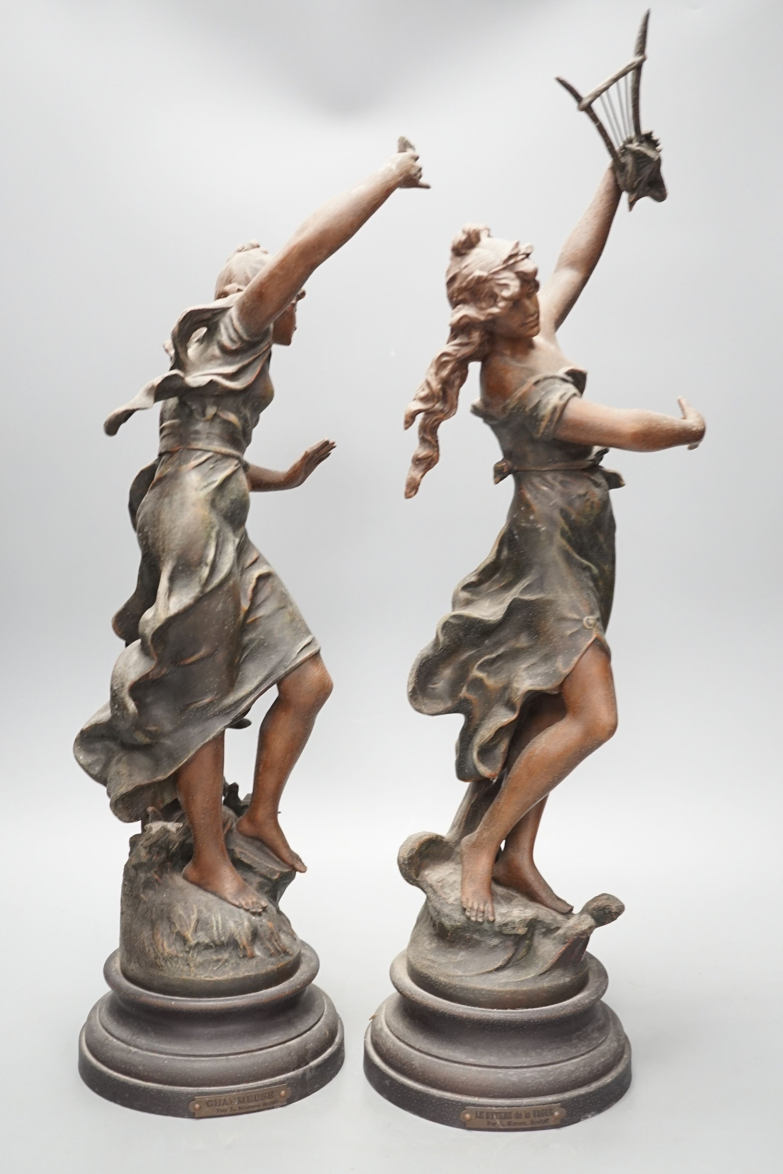 A pair of patinated spelter figures of musical maidens, tallest 58 cms high.